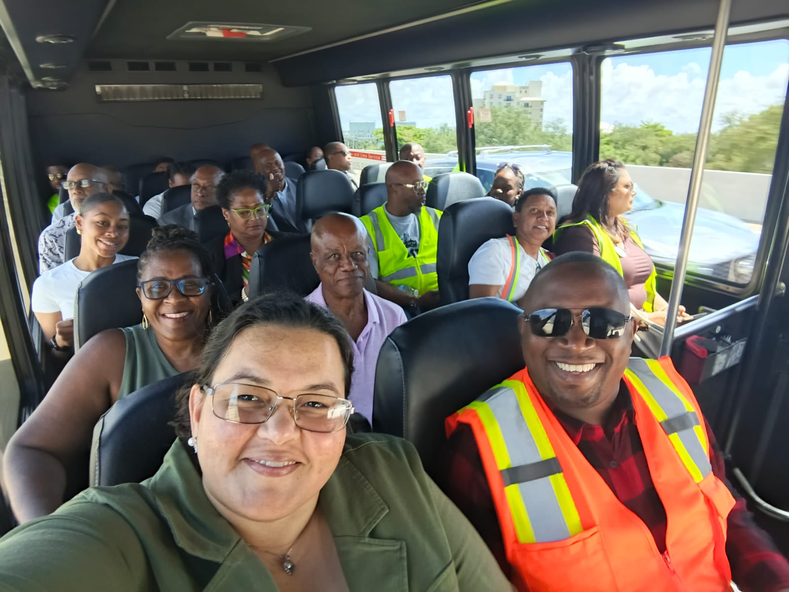 Smiling attendees, including customs brokers and industry leaders, during the PortMiami bus tour. The photo highlights the camaraderie and community spirit at CACUB 2025.