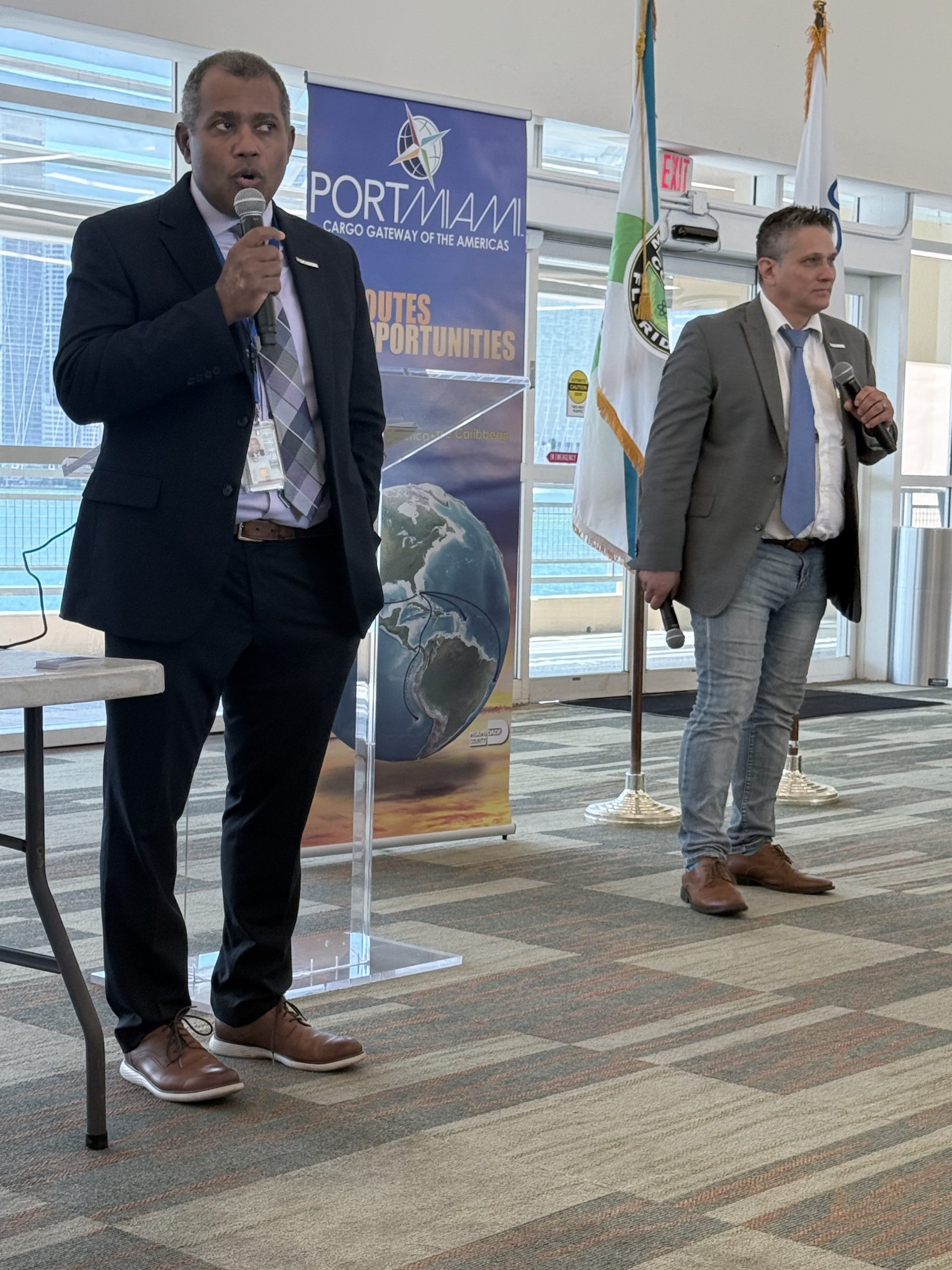 A speaker presenting on stage at the CACUB Biennial Conference 2025. The setting captures the professional atmosphere, with insights being shared on trade, customs, and logistics.