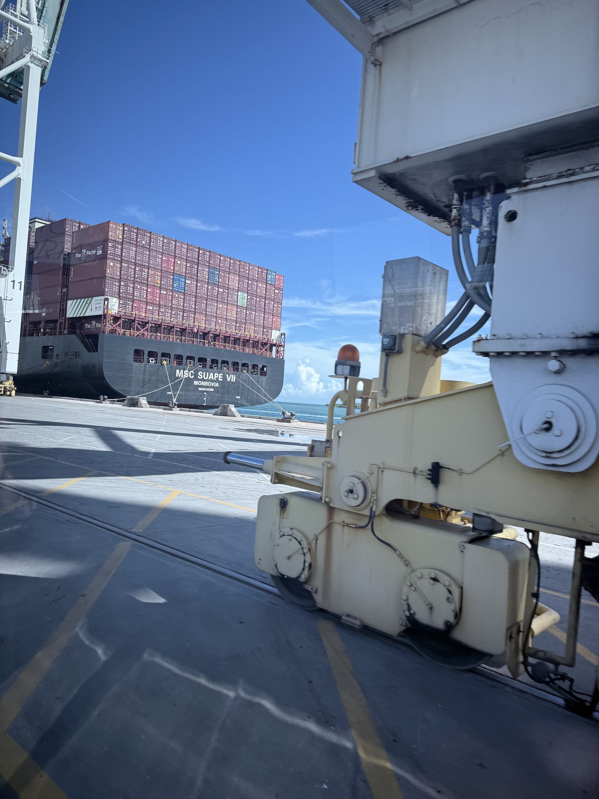A close-up view of a container being lifted by port equipment at PortMiami. This demonstrates the efficiency and operations behind large-scale shipping.