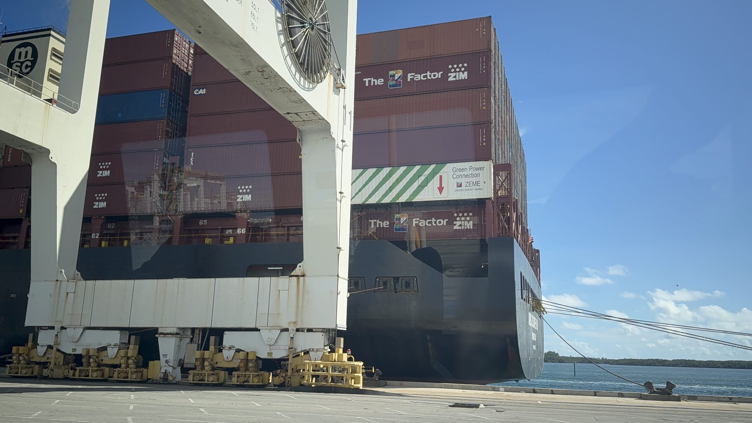 A large container ship docked at PortMiami, highlighting the massive scale of maritime trade that connects the Caribbean with global markets.