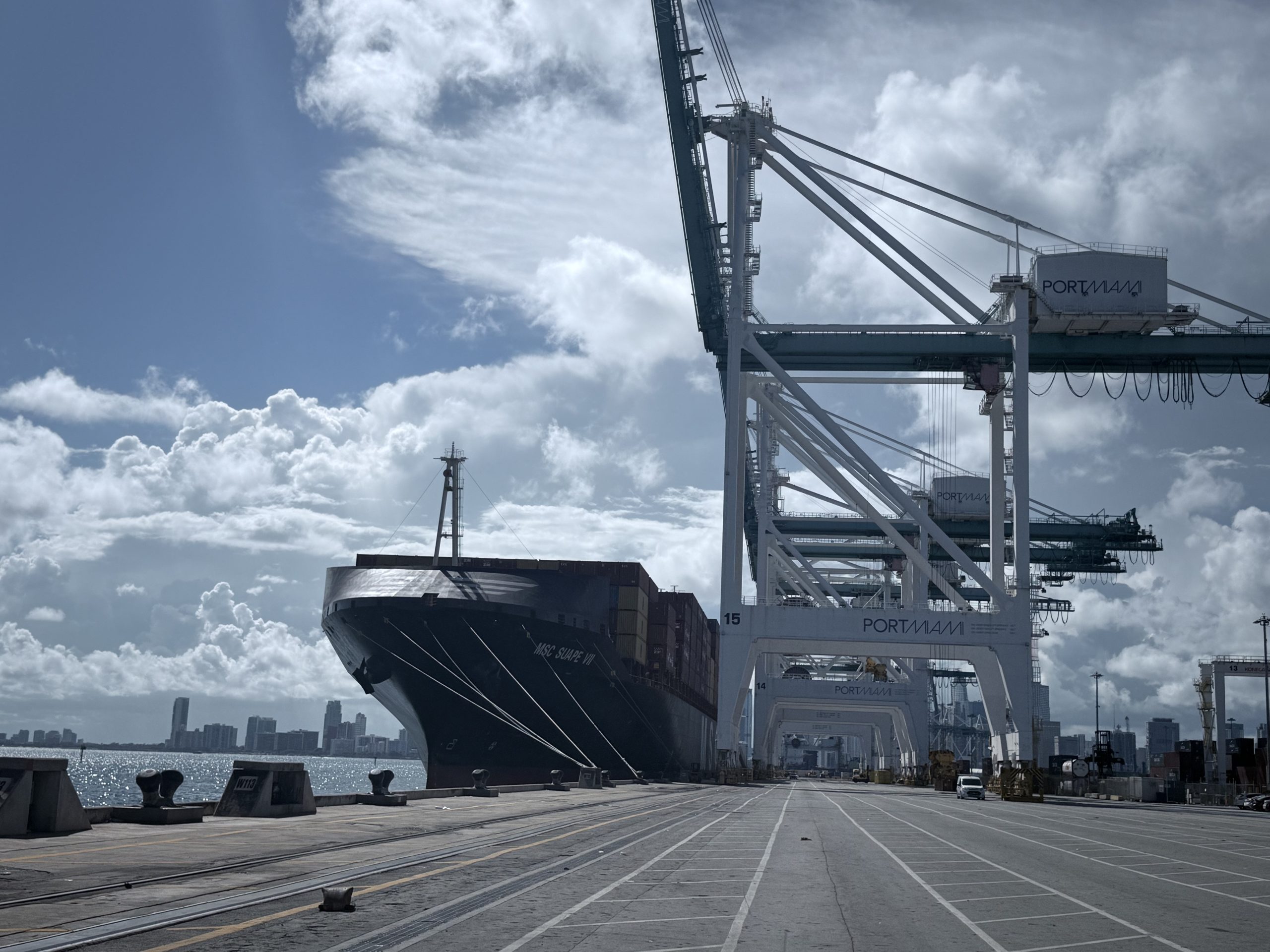 A large container ship docked at PortMiami, highlighting the massive scale of maritime trade that connects the Caribbean with global markets.