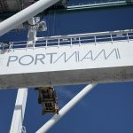 A photo of the “PORTMIAMI” signage on cargo-handling equipment, symbolizing the gateway role Miami plays in Caribbean and Latin American trade.