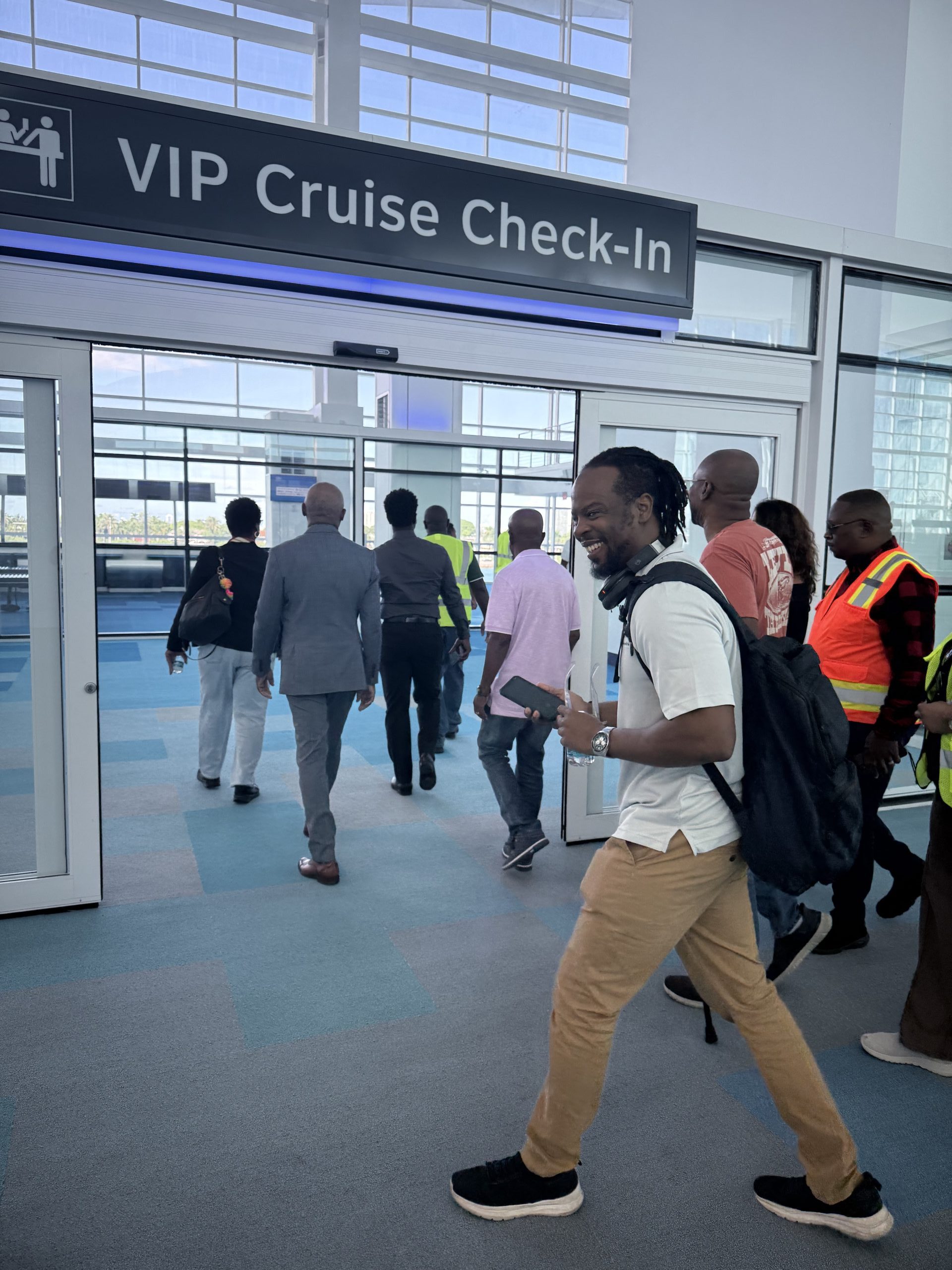 Delegates at the CACUB 2025 conference walking through the VIP Cruise & Check-in area during the PortMiami tour. This shows the integration of passenger and cargo facilities.