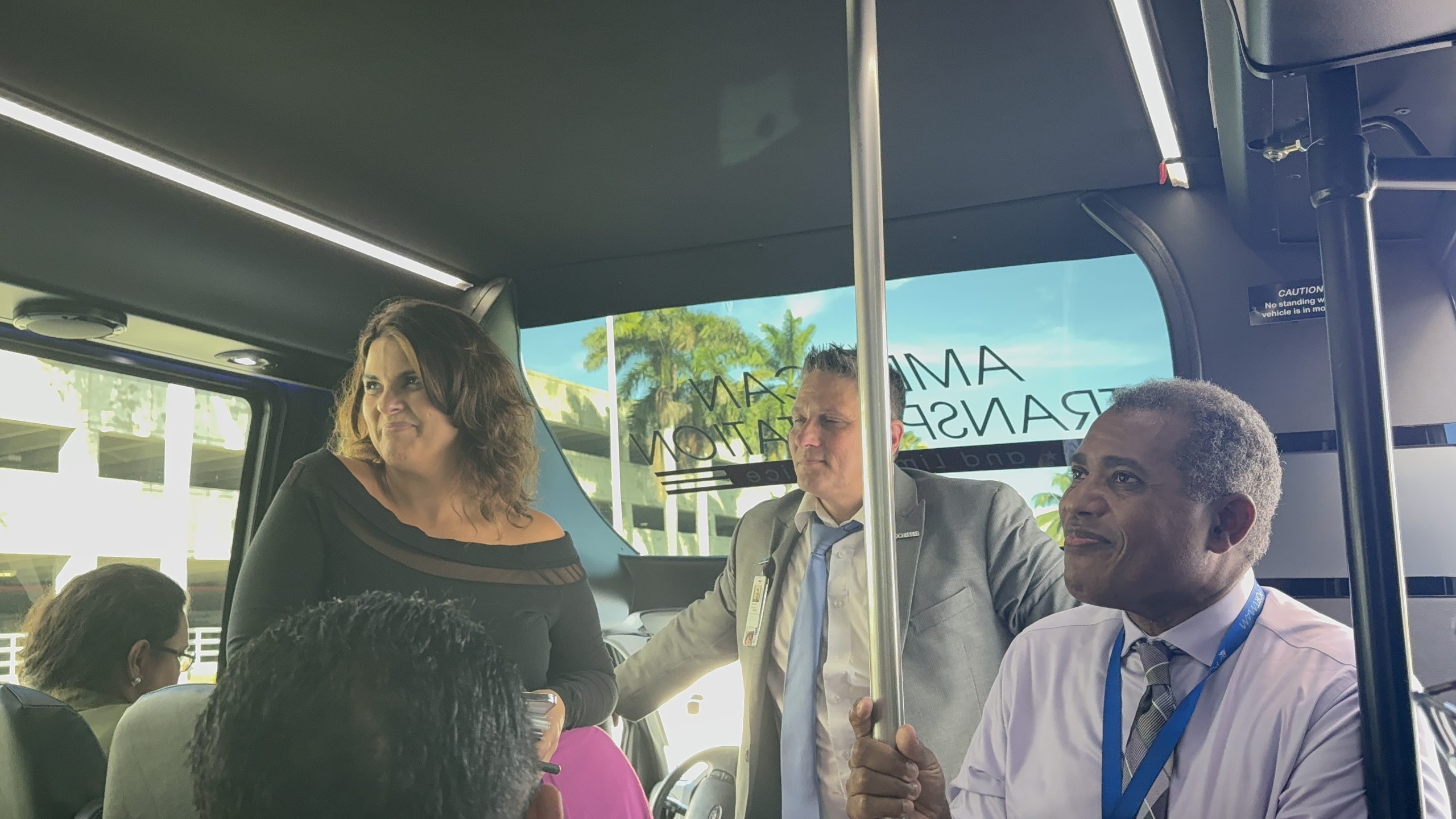 Conference attendees seated inside a bus during the PortMiami facility tour. The image captures networking and casual moments in between sessions.